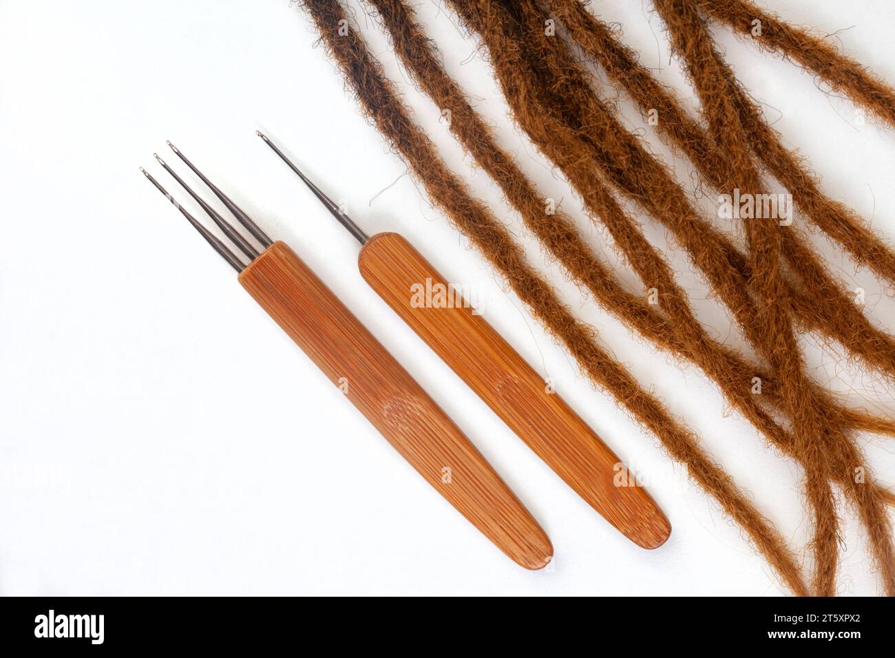 Hair crochet needles and decorative beads for dreadlocks and braids on white Stock Photo