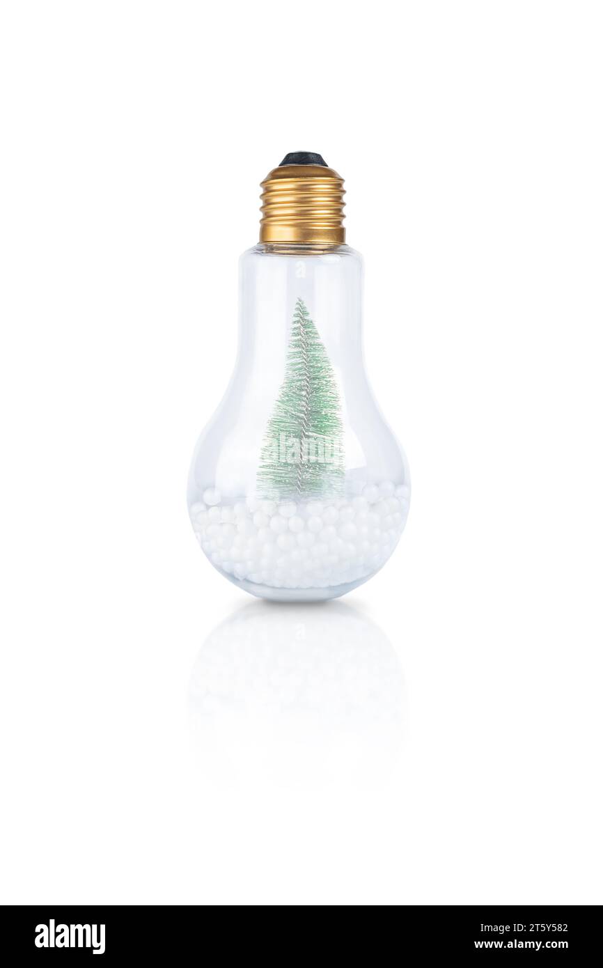 Christmas tree inside light bulb with artificial snow isolated on white