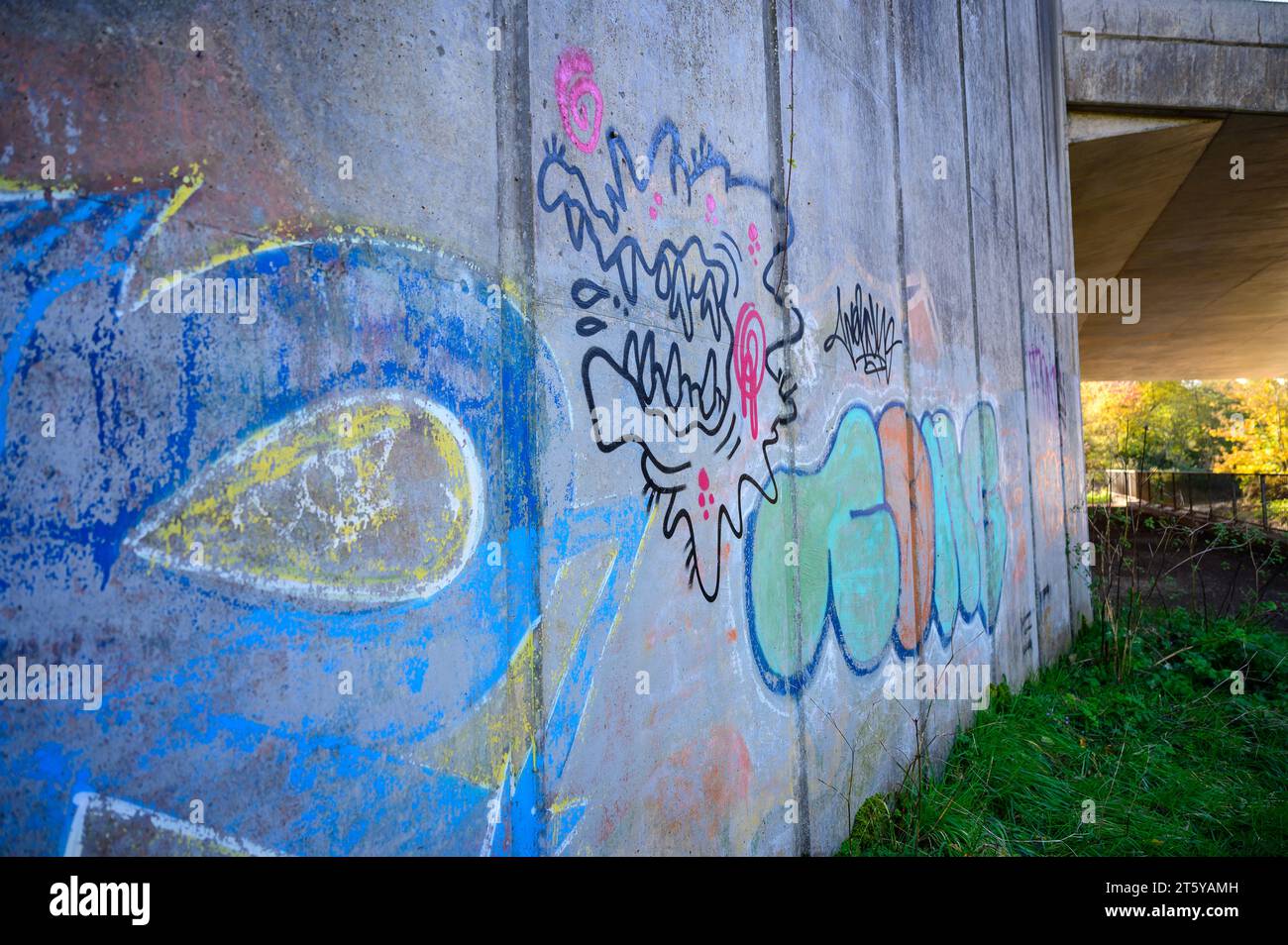 Graffiti spray painted on a concrete underpass. Stock Photo
