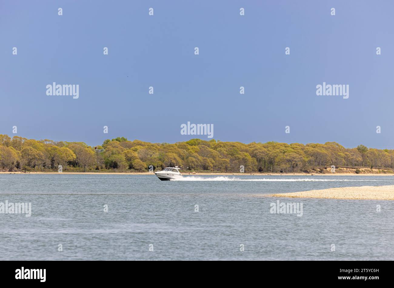 large white power boat underway off shelter island on a summer day Stock Photo