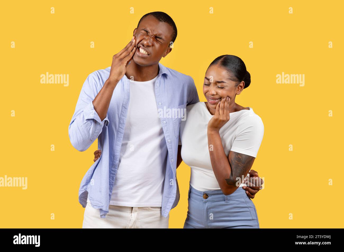 African american man and woman touching cheeks in discomfort. Stock Photo