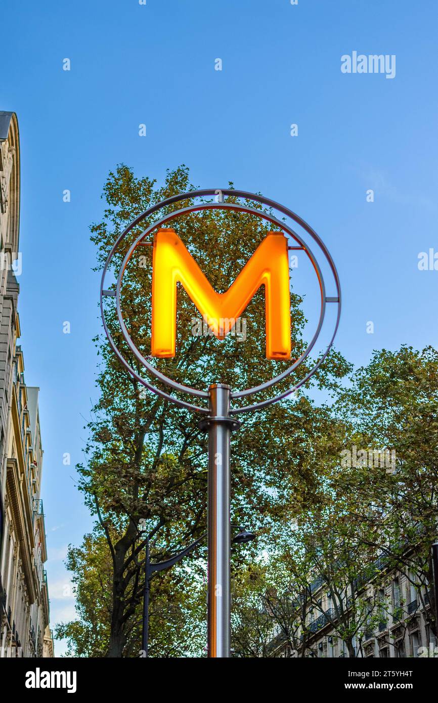 Modern Paris Métro underground station sign, lit in early evening - Paris, France. Stock Photo