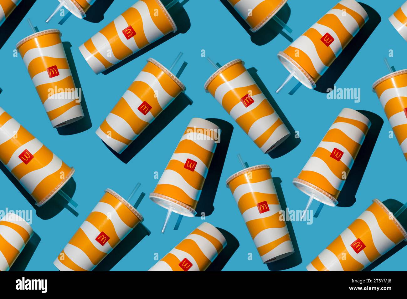 Yellow glass of McDonald's. Paper cup with lid. Takeaway drink ...