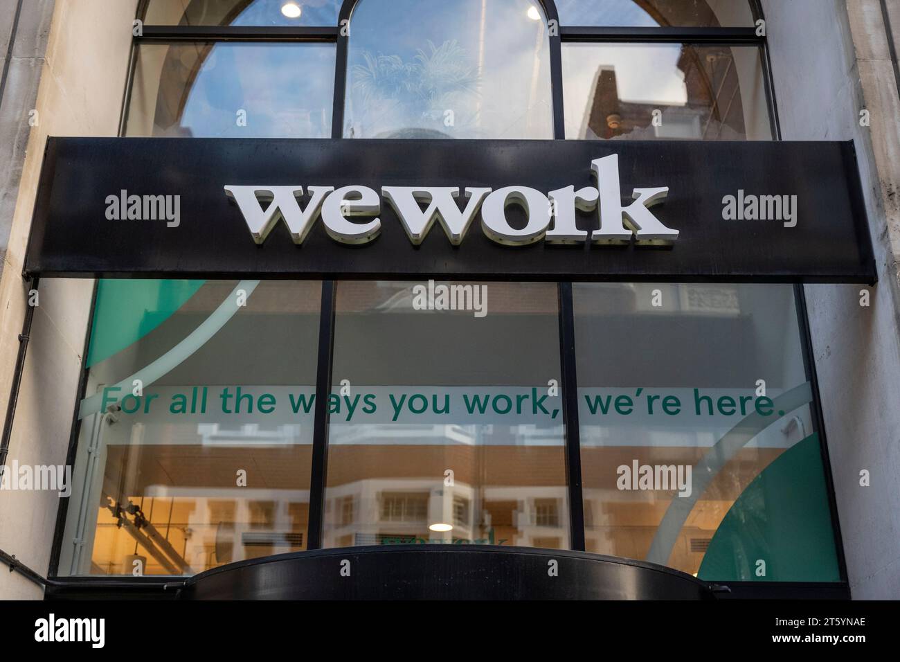 London, UK.  7 November 2023.   Signage on the exterior of the WeWork premises on Long Acre, Covent Garden.  WeWork has filed for bankruptcy in the US as it struggles to pay off billions of dollars of debt.  For now, locations outside the US and Canada are not part of the bankruptcy process and remain operational.  The office space sharing company was once valued at $47bn but a 98% decline in its share price this year values it at less than $50m.  Credit: Stephen Chung / Alamy Live News Stock Photo