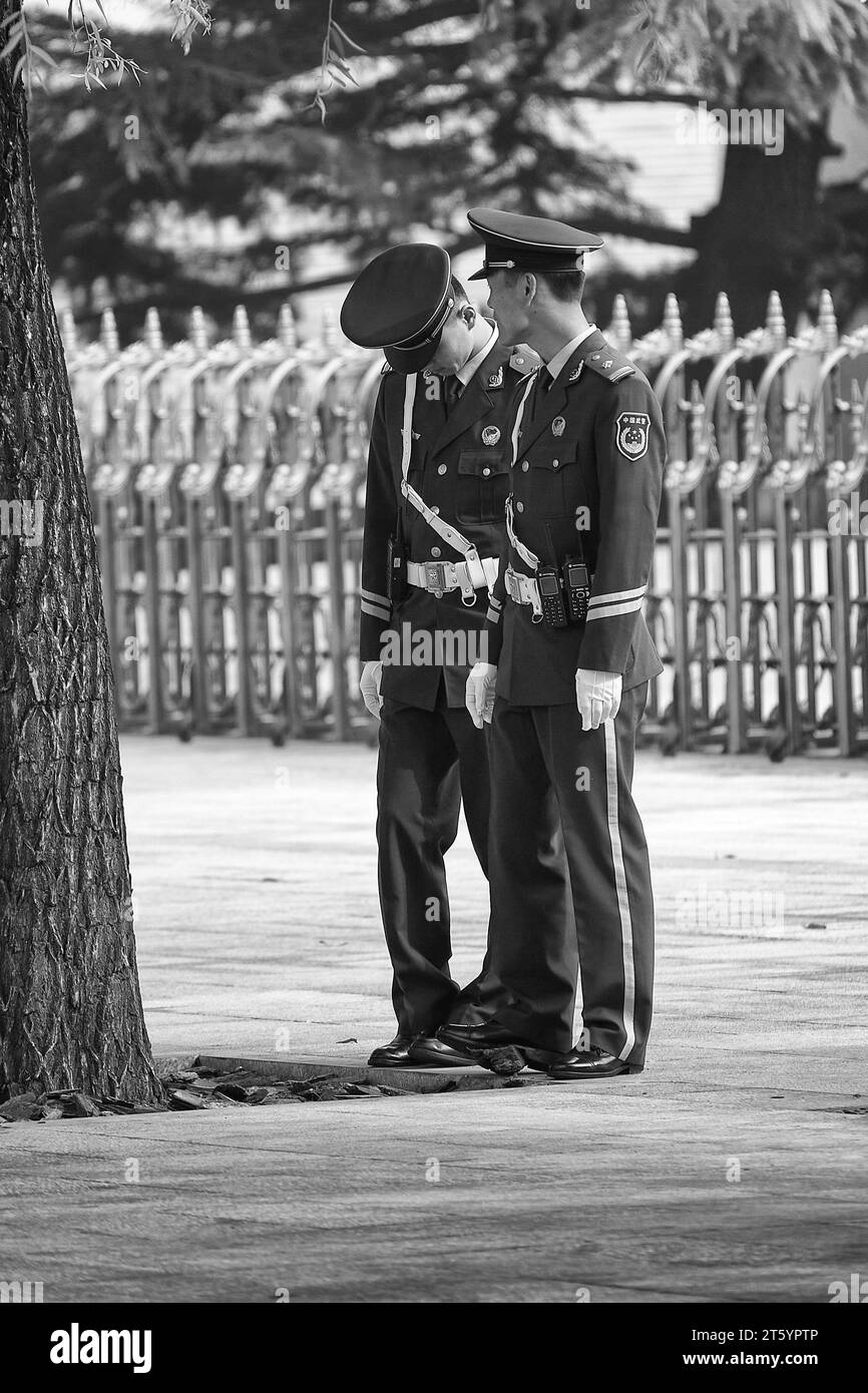 Black And White Photo Of Two People's Liberation Army Soldiers Talking Near Tiananmen Square, Beijing, China. Stock Photo