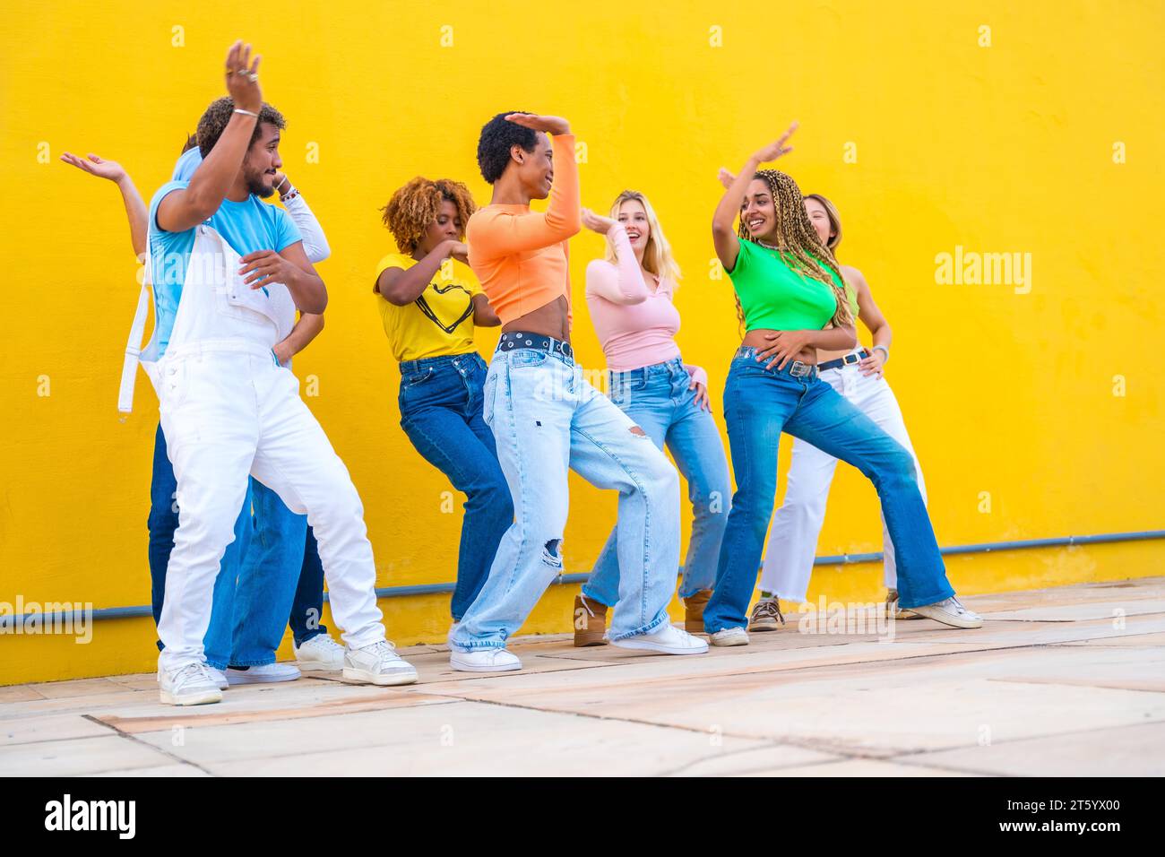 Group of diverse ethnicities dancing a joint choreography in the street ...