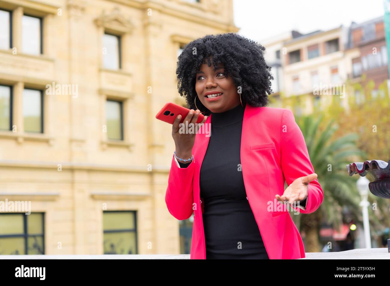 African american businesswoman sending a voice message using phone in ...