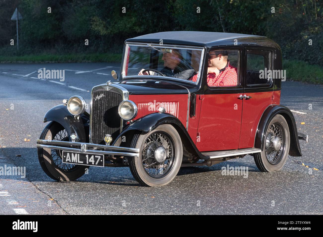 A red and black 1933 Austin 10 motor car on the road, England, UK Stock Photo