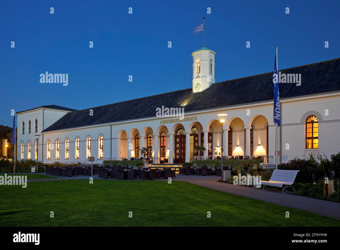 Illuminated Conversationshaus with spa garden in the evening, Norderney Island, Lower Saxony, Germany Stock Photo