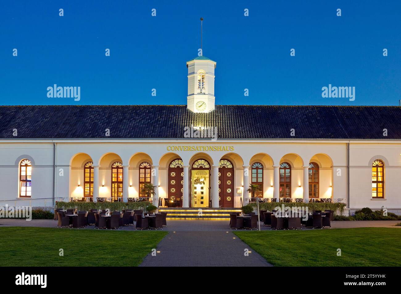 Illuminated Conversationshaus with spa garden in the evening, Norderney Island, Lower Saxony, Germany Stock Photo