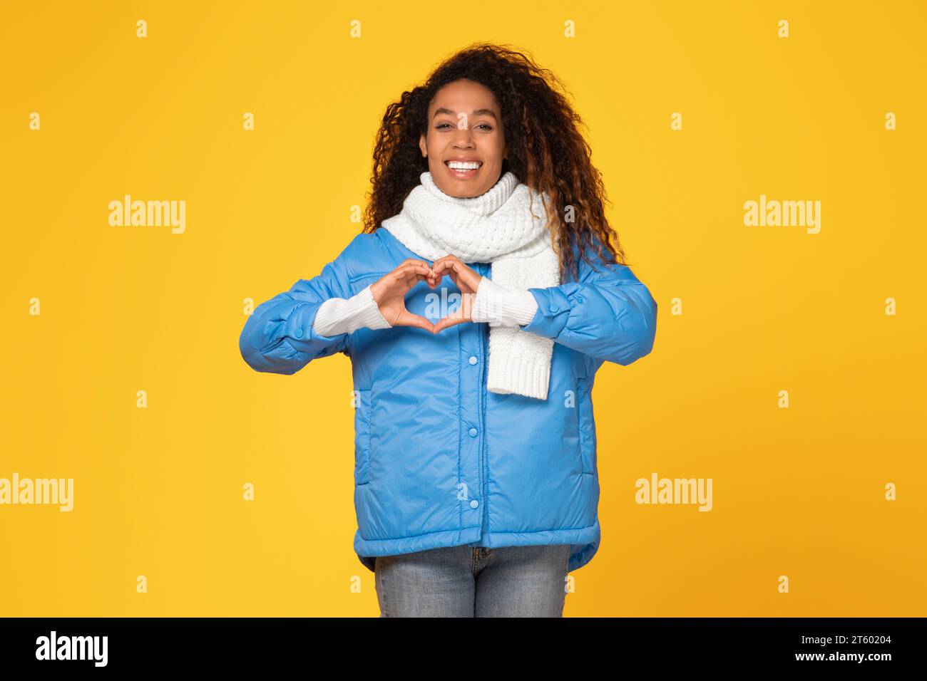 Smiling black woman makes heart hi-res stock photography and images - Alamy