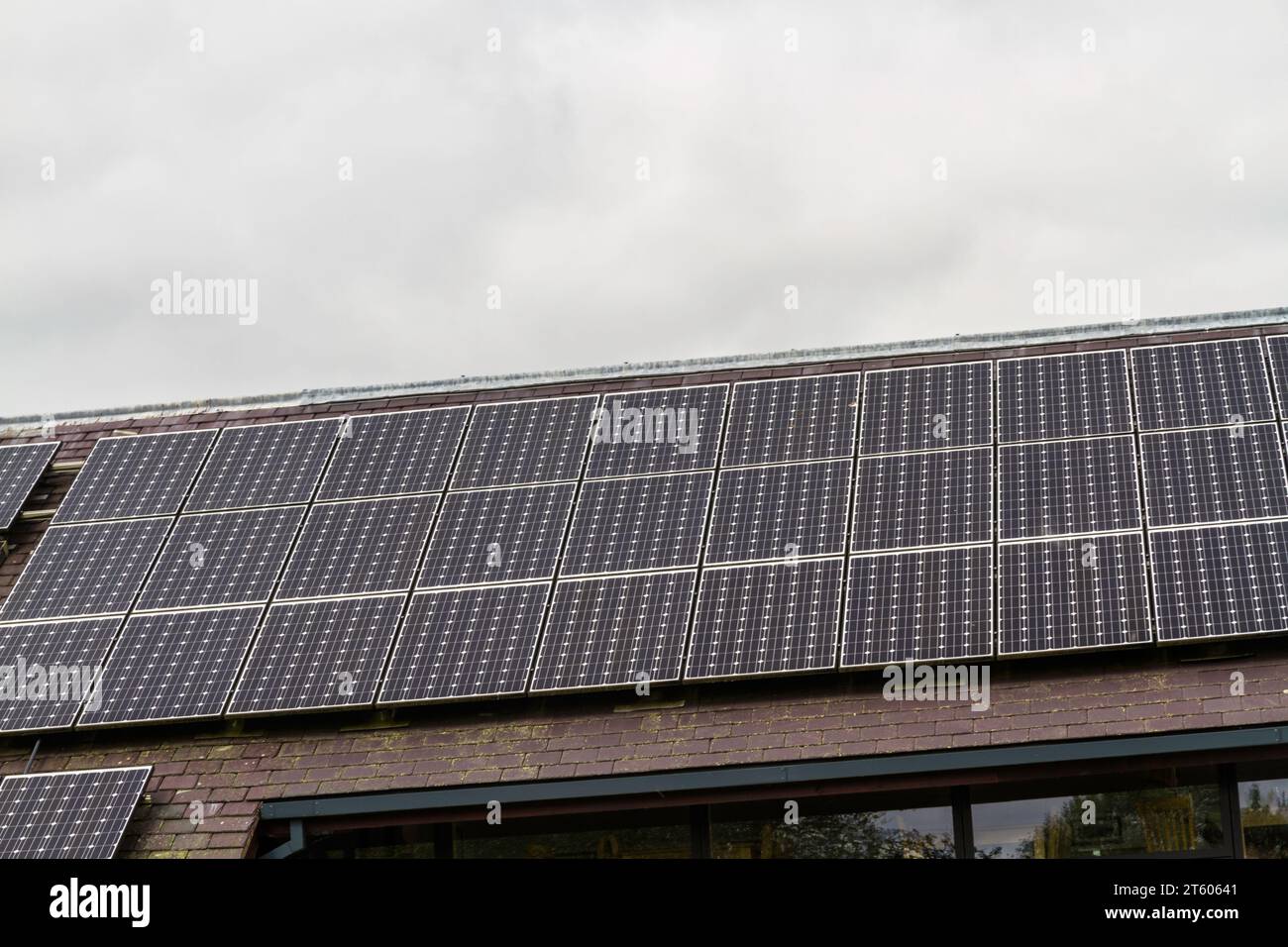 Three rows of solar panels mounted on a roof. Stock Photo