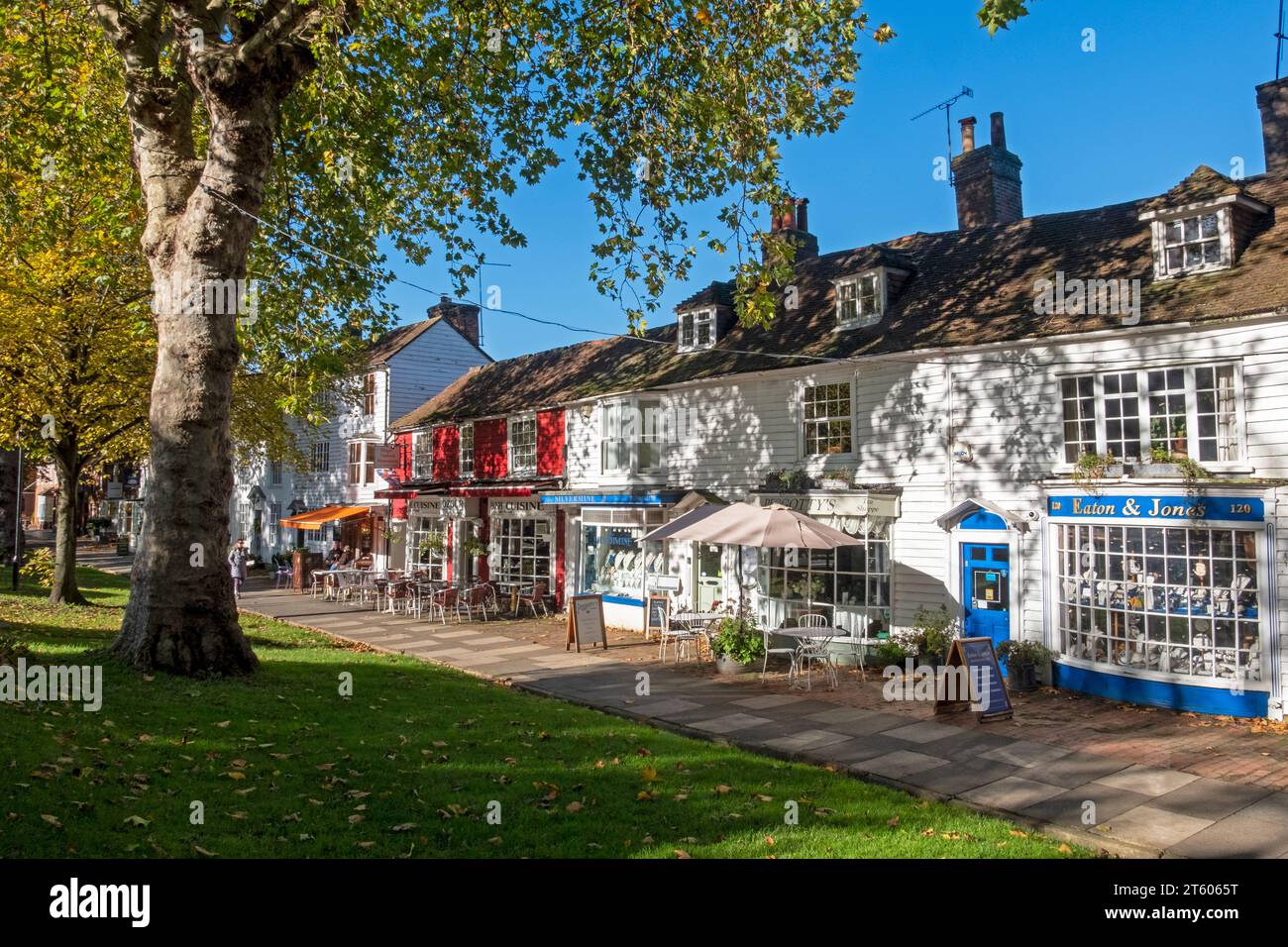 Tenterden High Street, wide pavement with shops and cafes, on a sunny  autumn day, Kent, UK Stock Photo