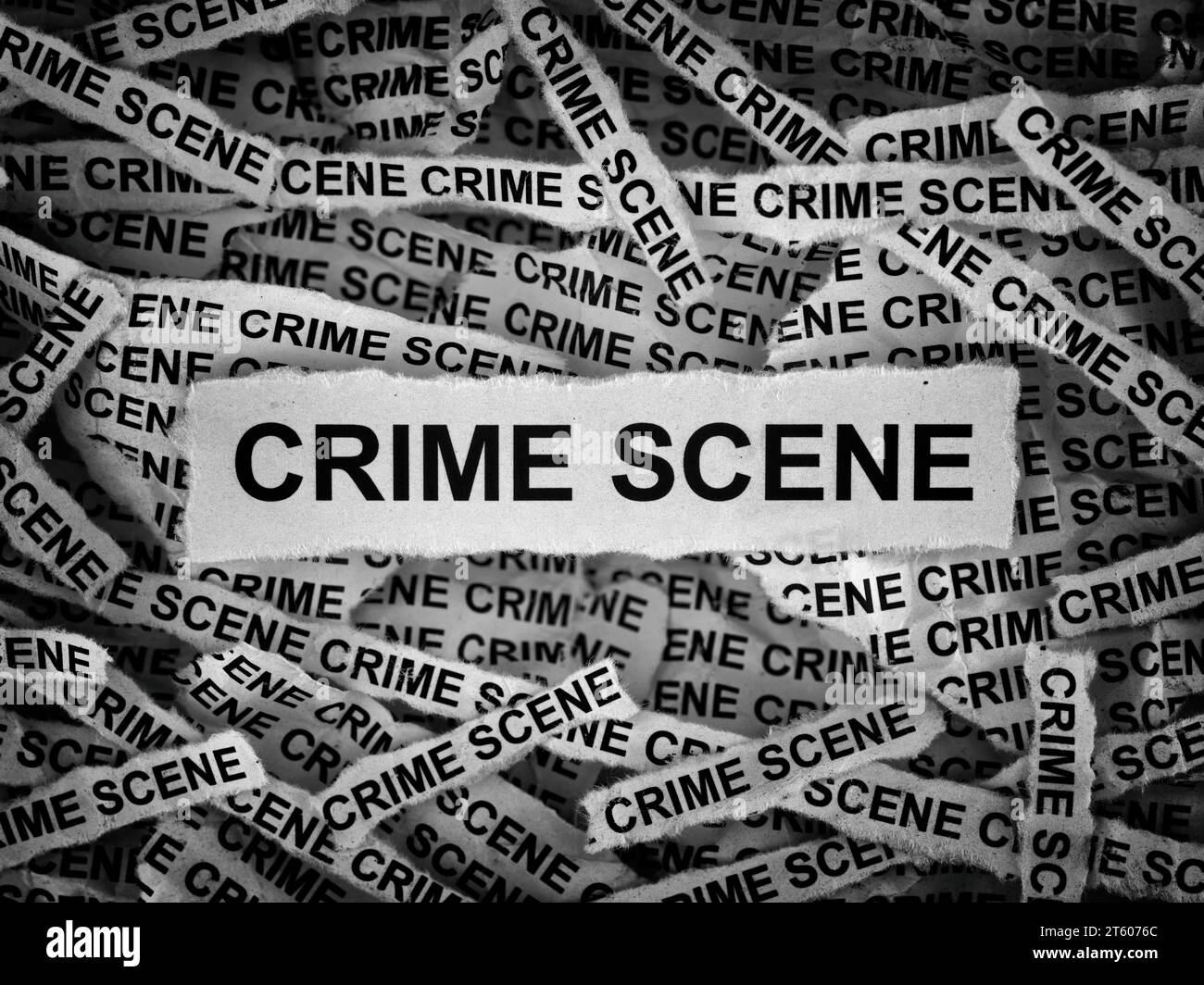 Strips of newspaper with the words Crime Scene typed on them. Black and white. Close up. Stock Photo