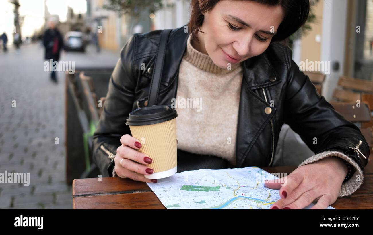 Stylish Female Tourist Checks City Sightseeing Route On Map While