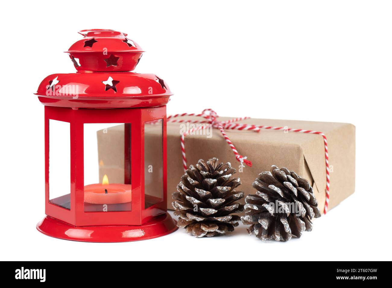 Burning red lantern with Christmas gift box and green fir branch isolated on white background Stock Photo