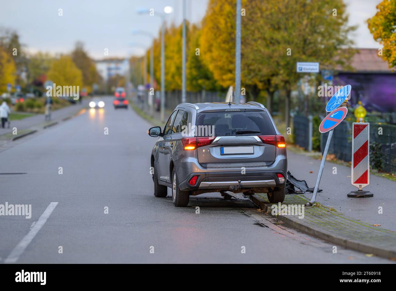 A car has knocked down a traffic sign Stock Photo
