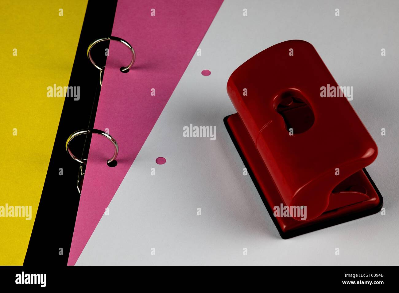 Open ring binder with coloured card and white paper sheet and hole