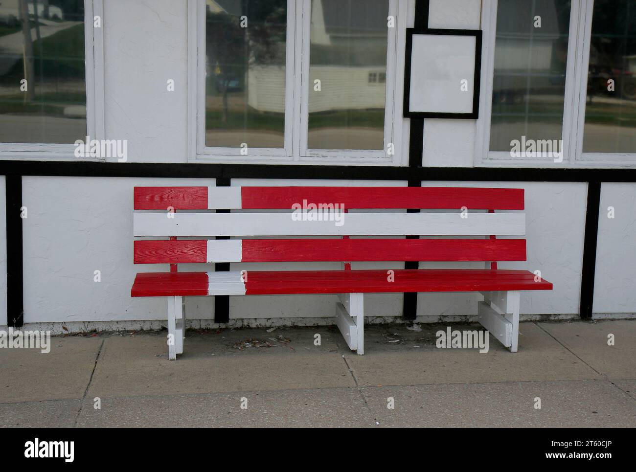 Wooden Bench with Danish Flag Paint in front of Building in Elk Horn, Iowa Stock Photo