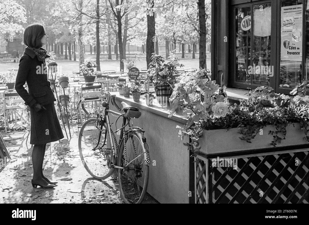 1960s, woman fashion model looking at food and drinks kiosk, Jardin des Tuileries garden, Paris, France, Europe, Stock Photo