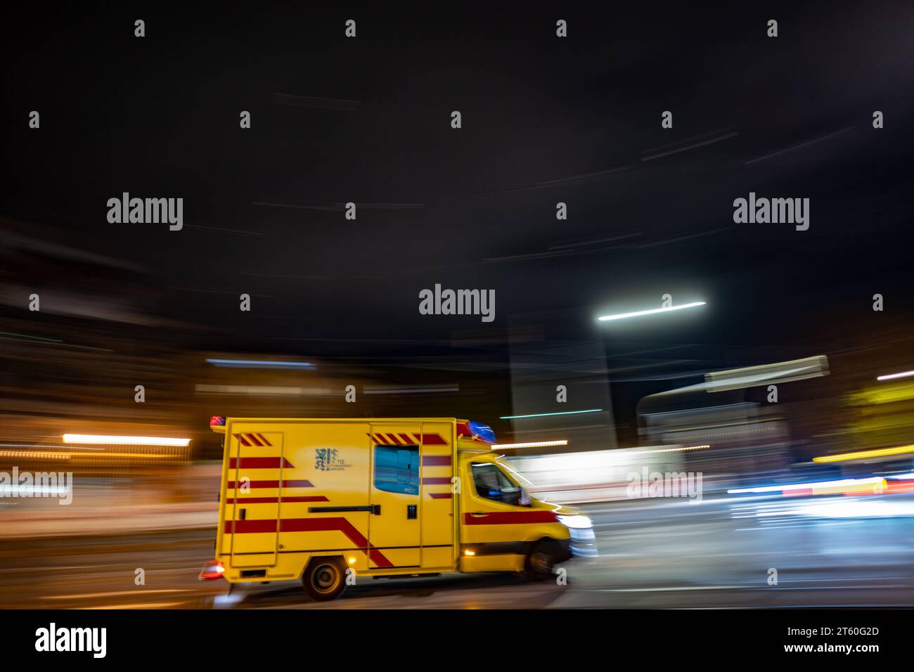 Dresden, Germany. 07th Nov, 2023. An ambulance from the Dresden fire department drives along the Johannstadt district in the evening. (Shot with long exposure time) Credit: Robert Michael/dpa/Alamy Live News Stock Photo