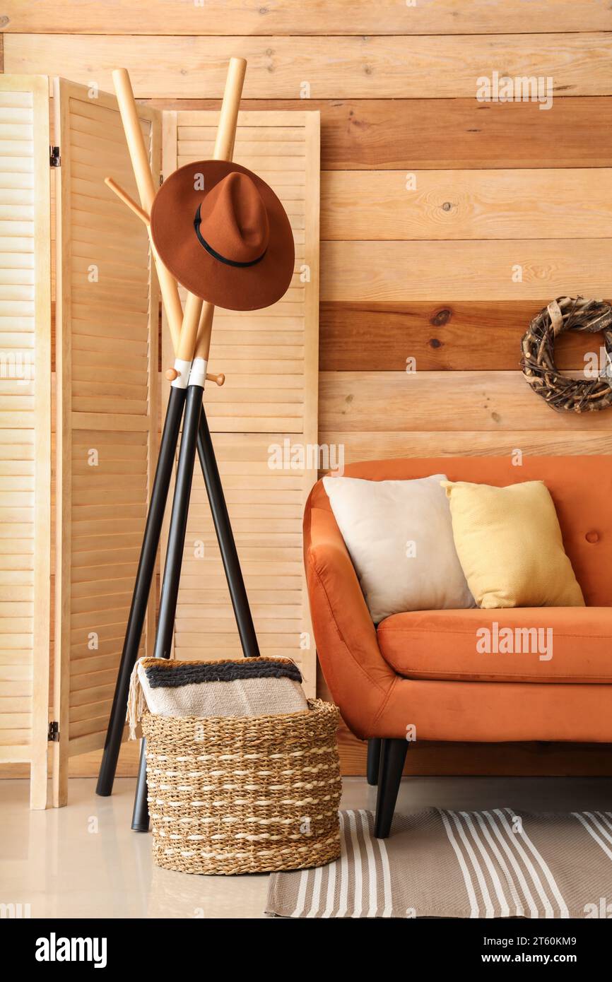 Interior of living room with brown sofa, rack, and folding screen Stock ...