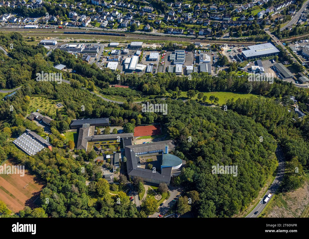 Aerial view, Maria Königin private grammar school and Maria Königin church, railroad depot industrial estate, Altenhundem, Lennestadt, Sauerland, Nort Stock Photo