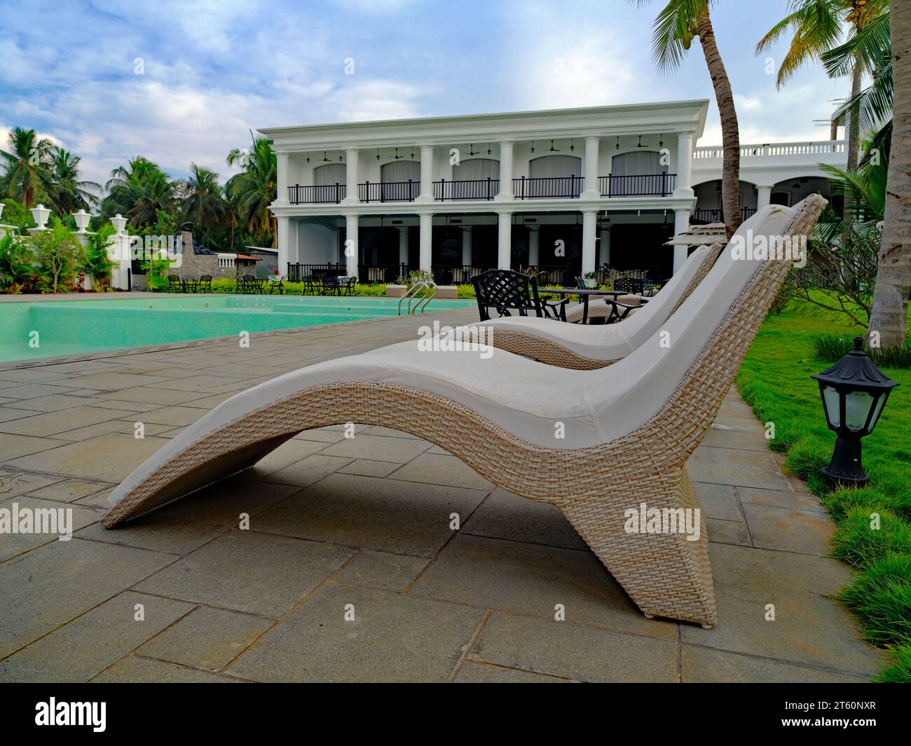 Sun loungers near swimming pool in a resort Stock Photo Alamy