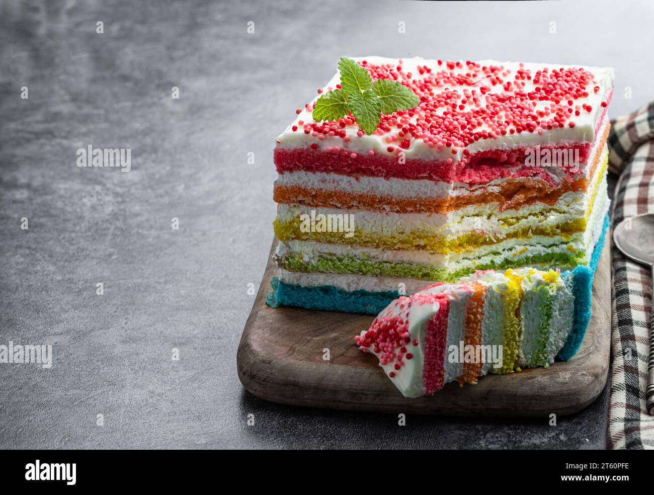Multicolored  rainbow cake on gray background Stock Photo