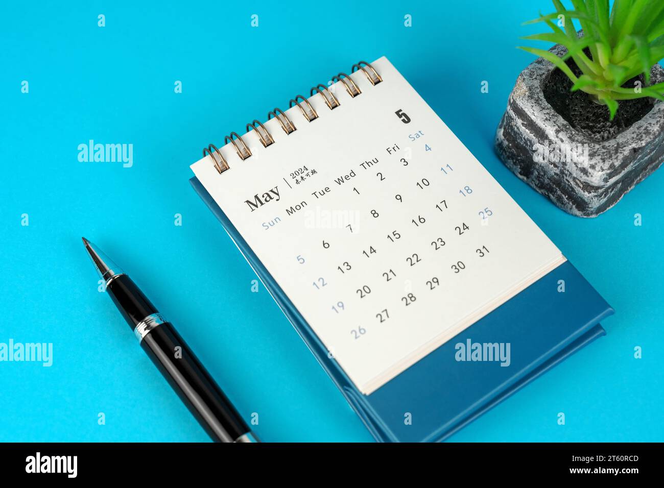 May 2024 Desk Calendar on Blue Background Stock Photo