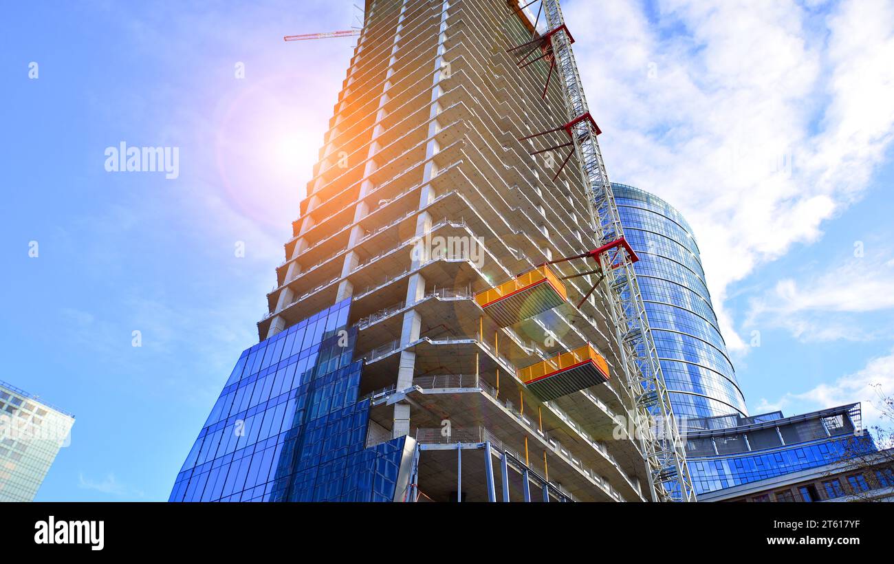 High rise building under construction. Installation of glass facade ...