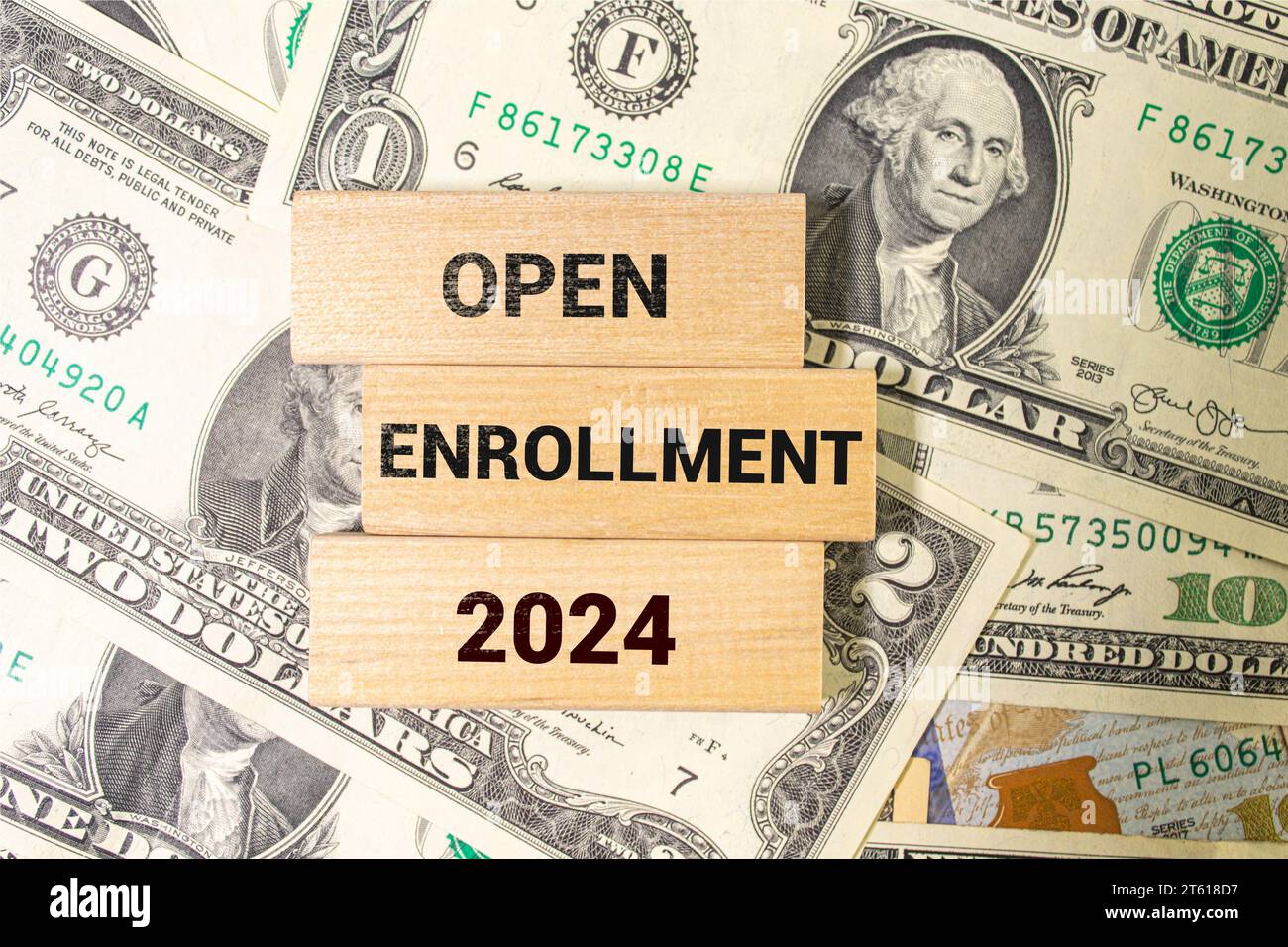 open enrollment 2024. text on a sticker next to money and banknotes