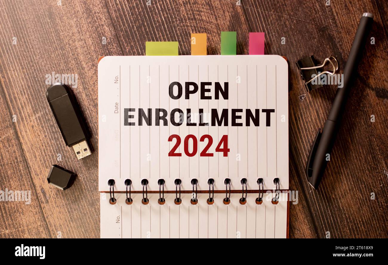 open enrollment 2024. text on a sticker next to money and banknotes