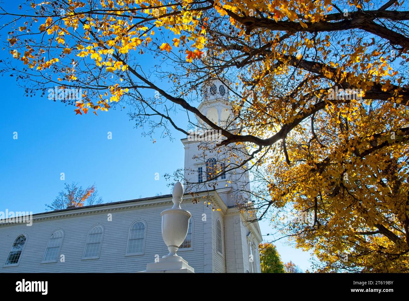 1806 Old First Congregational church in Bennington Vermont framed in brightly lit fall leaf colors Stock Photo