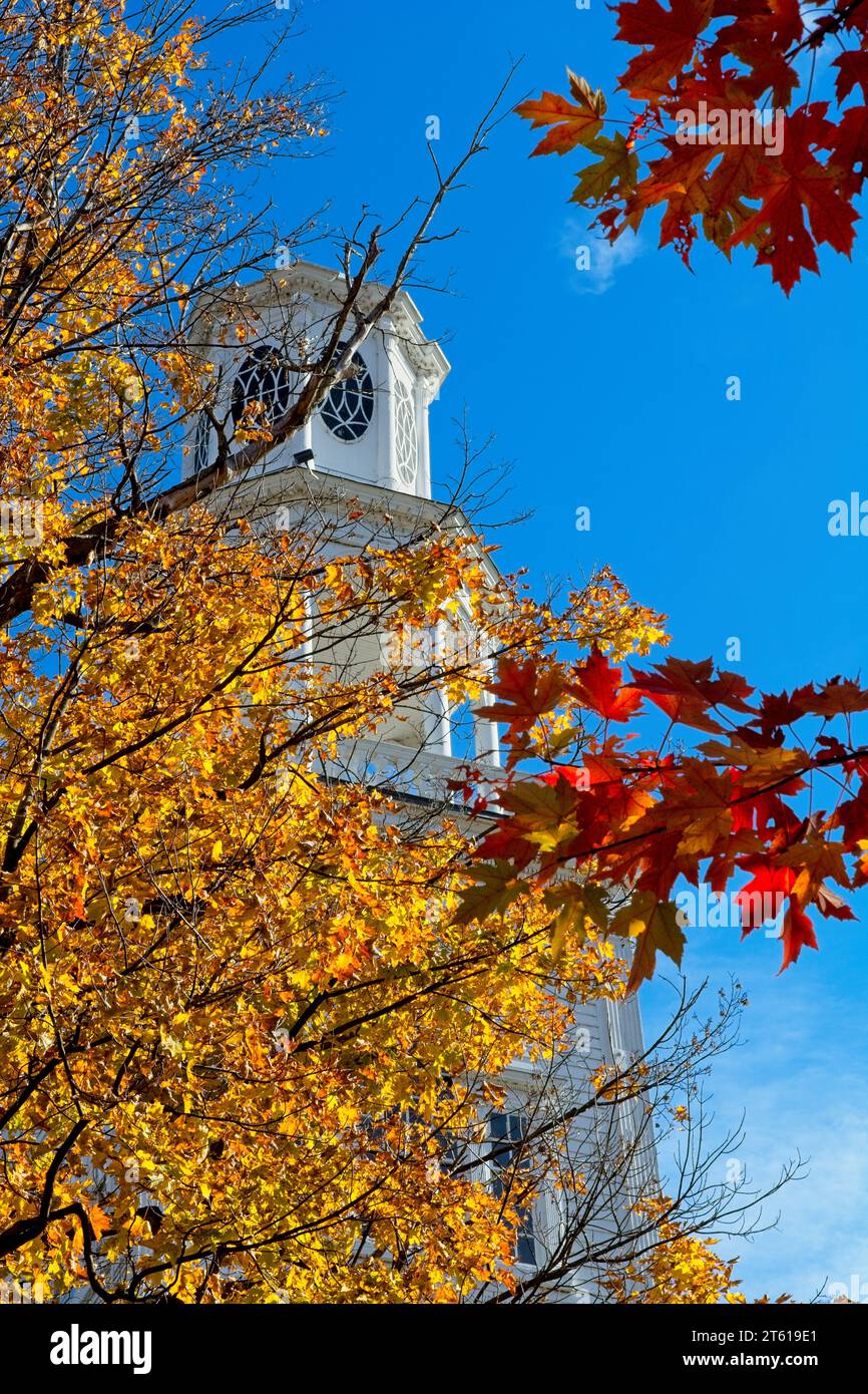 1806 Old First Congregational church bell tower in Bennington Vermont under blue sky brightly lit fall leaf colors Stock Photo