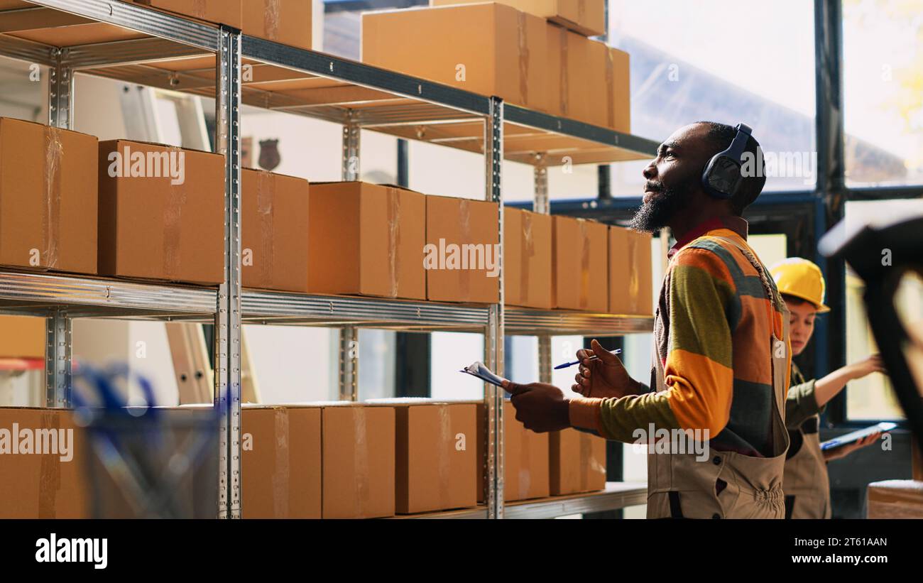 Someone Inspecting Inventory Supervisor inspecting stock logistics with inventory list, looking at ...