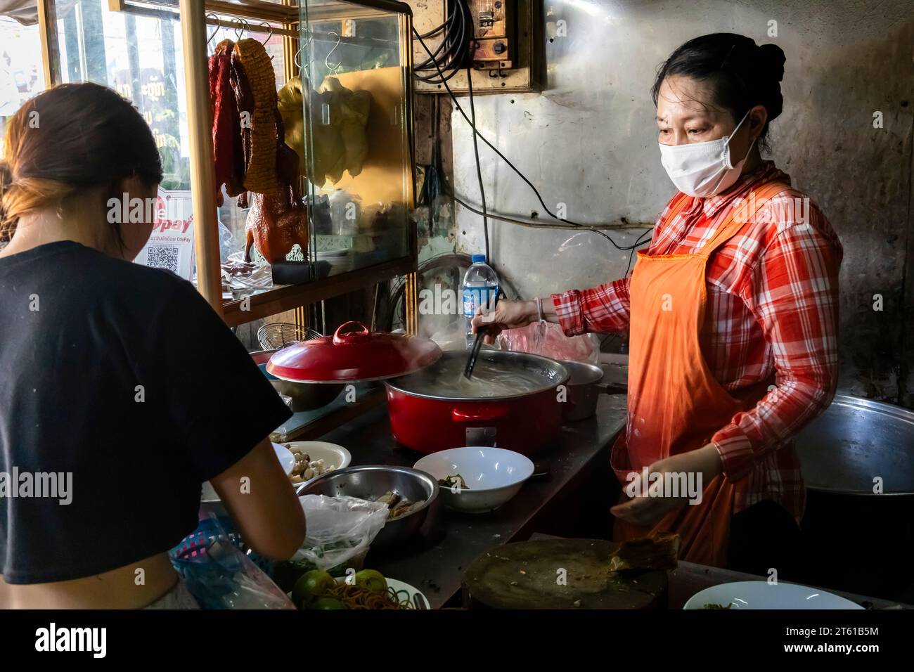 Noodle soup restaurant, woman cooking, street of city center, Vientiane, Laos, Southeast Asia, Asia Stock Photo