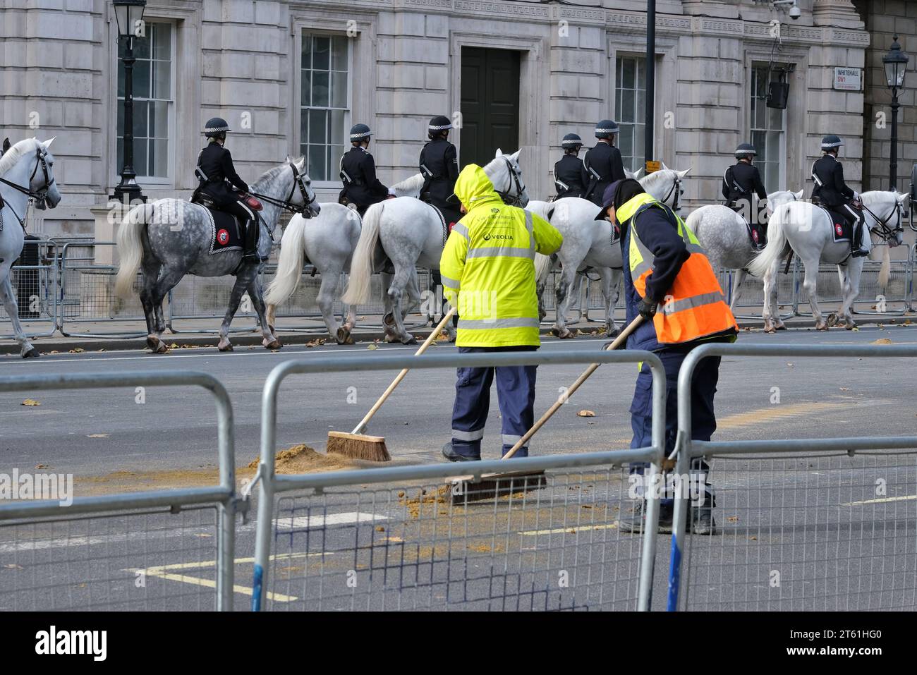 London, UK. Street cleaners clear the road of waste after ceremonial horses have passed through Whitehall. Stock Photo