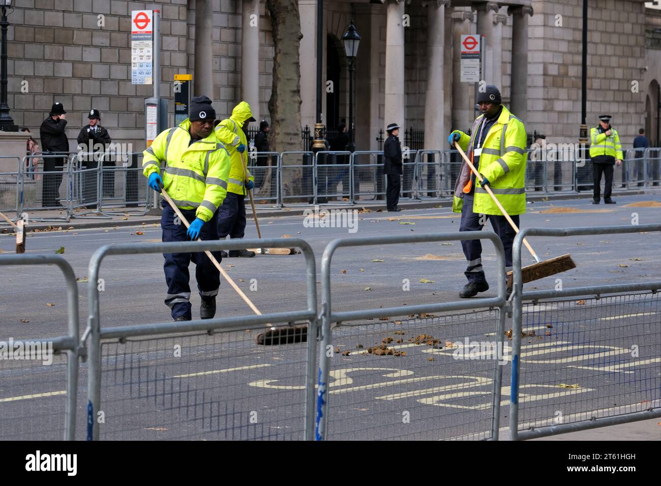 London, UK. Street cleaners clear the road of waste after ceremonial horses have passed through Whitehall. Stock Photo