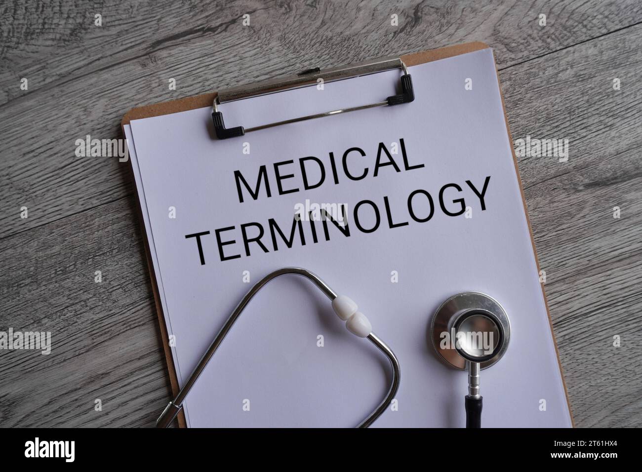 Top view image of stethoscope and paper clipboard with text MEDICAL TERMINOLOGY. Medical and healthcare concept. Stock Photo
