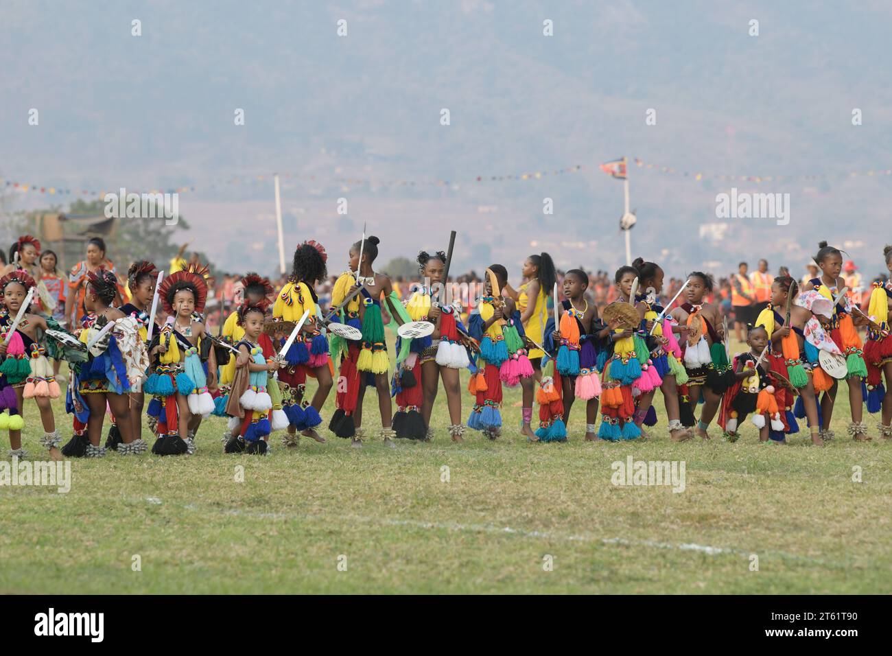 Row of young girls in traditional dress at Umhlanga reed dance festival 2023, Kingdom of Eswatini, group of children dancing, culture activity Stock Photo