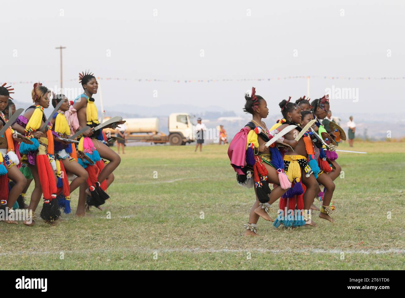 Group of girls dancing with young women in Umhlanga reed dance ceremony 2023, Kingdom of Eswatini, African culture event, females in traditional dress Stock Photo