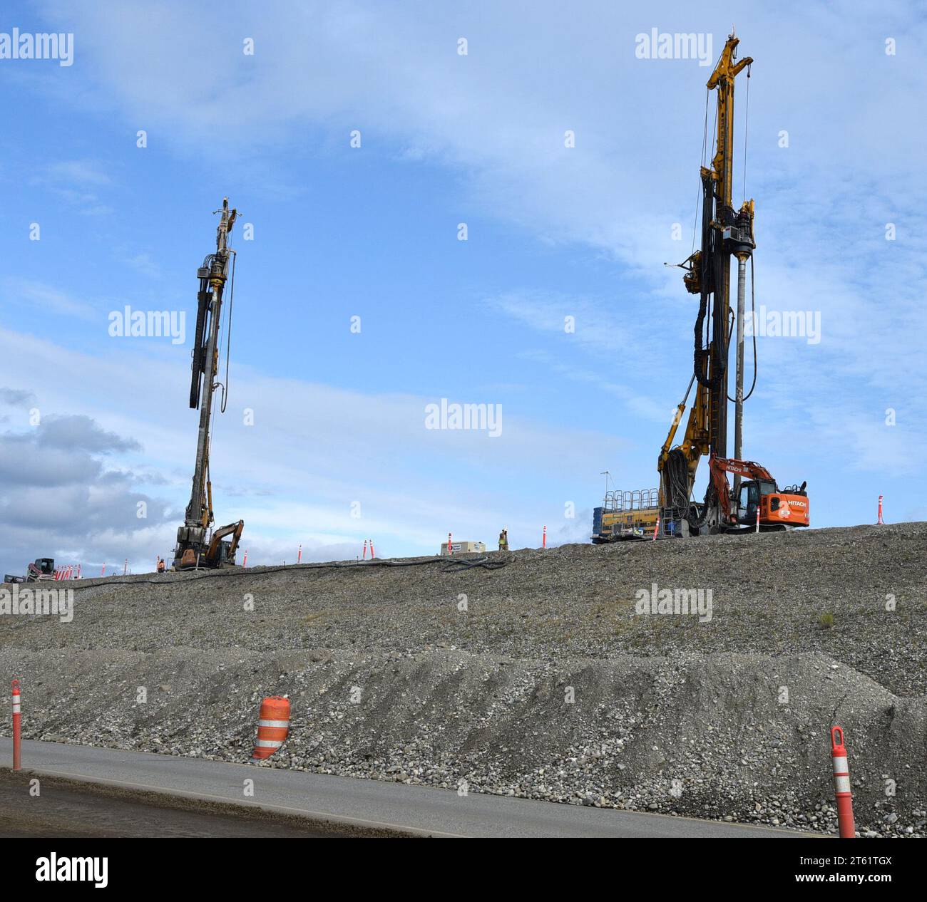 Construction equipment operates atop the 8milelong earthen embankment