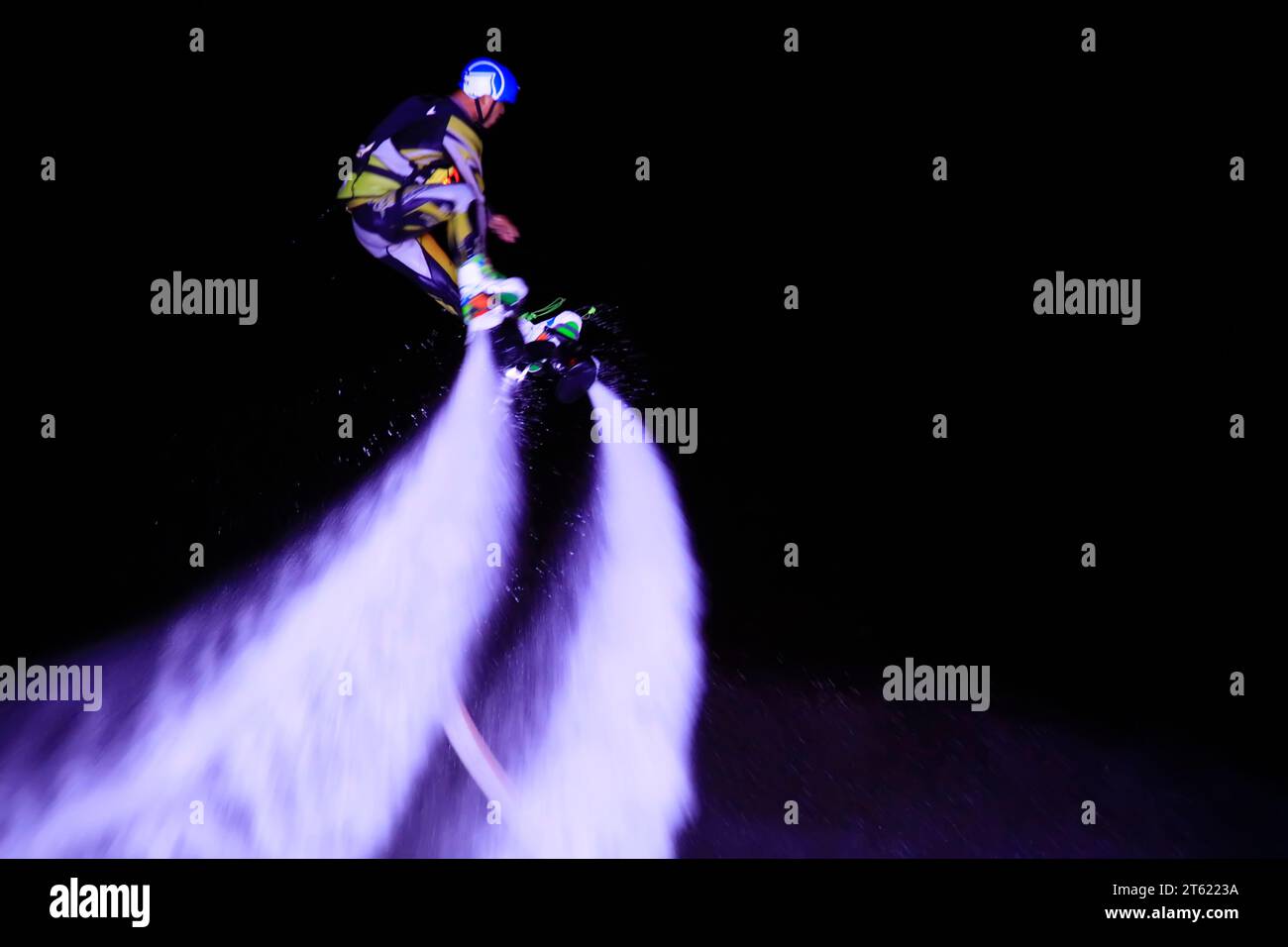 Water stunts performance at night in a park Stock Photo