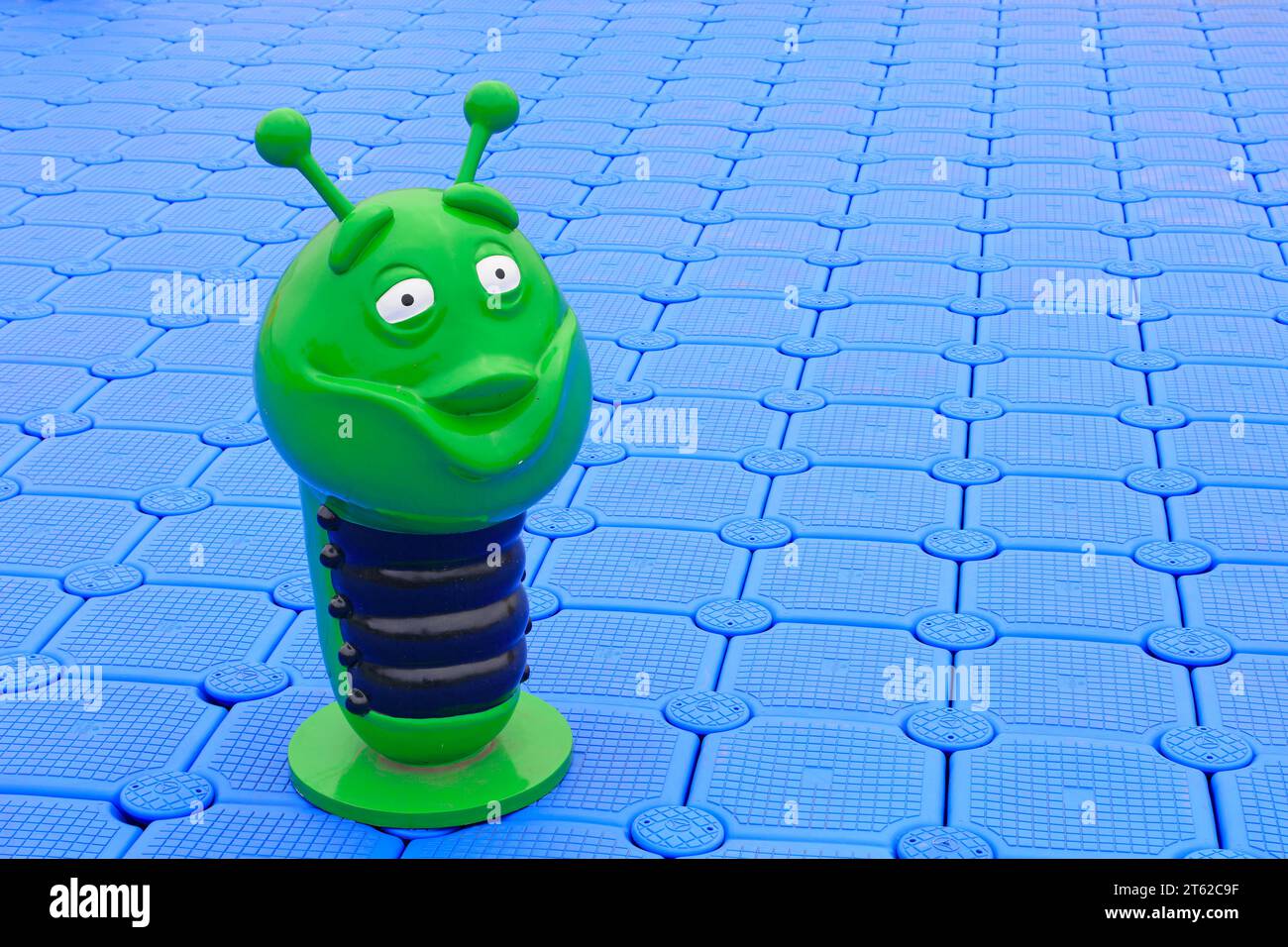 Plastic sculptures of green insects on the buoy deck Stock Photo