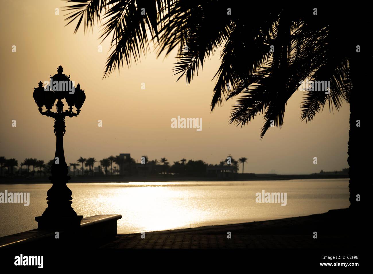 People walking and jogging in corniche during sunset. Stock Photo