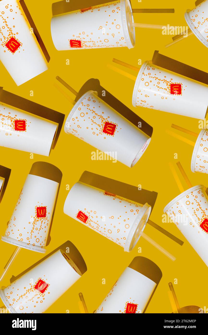Yellow glass of McDonald's. Paper cup with lid. Takeaway drink ...