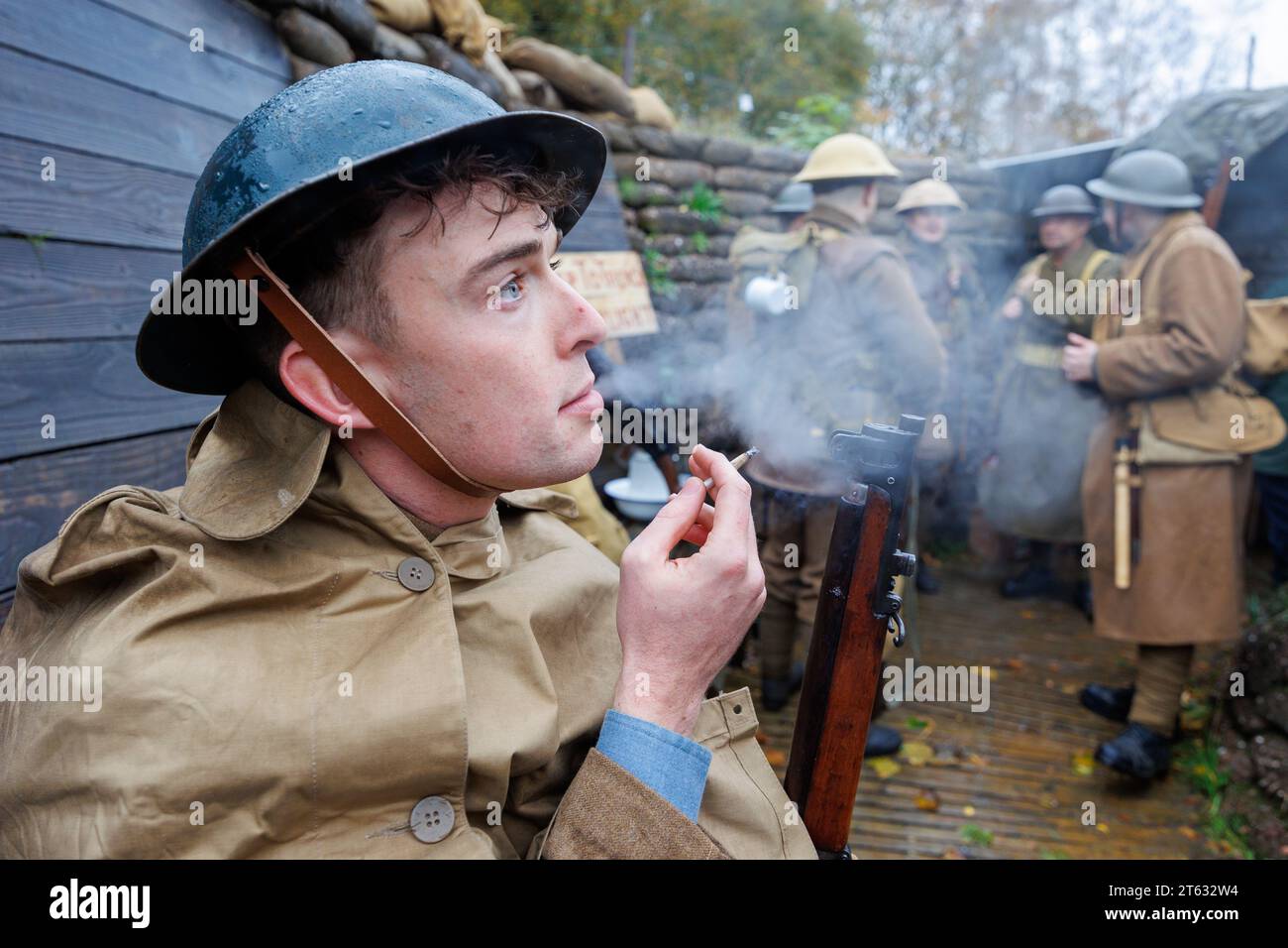 The Staffordshire Regiment Museum have built Trenches modelled on the real ones used in World War to give visitors an experience of what life was like for soldiers in the trenches. The museum holds events using reenactors to create the mood and bring to life history from the period. Pictured, Isaac Marlow (27)  from the Birmingham Pals troop lights a roll up cigarette in one of the trenches. Stock Photo