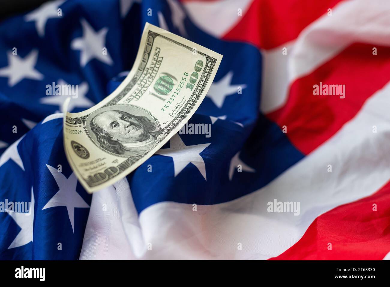 A hundred-dollar bill with the American flag. Crumpled dollars. Stock Photo