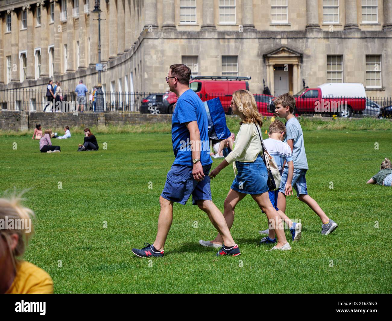 people enjoying the sunshine by the royal Crescent, Bath, Somerset, England, UK Stock Photo